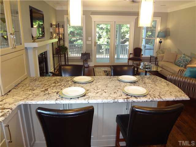 2321 Finley Ridge Lane Raleigh, NC 27615 - Photo 5 of 25 Close Up View From Kitchen Info Family Room. Bonus Storage Under Casual Dining Island. Natural Light Fills The Space. Great VIew Of Private Backyard and Screen Porch. Gas Fireplace And TV NIche. Den/Family/Great Room
