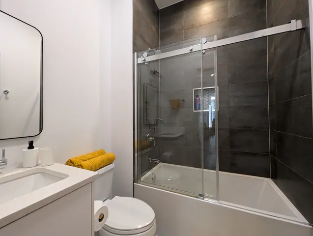 a bathroom with a sink toilet and shower