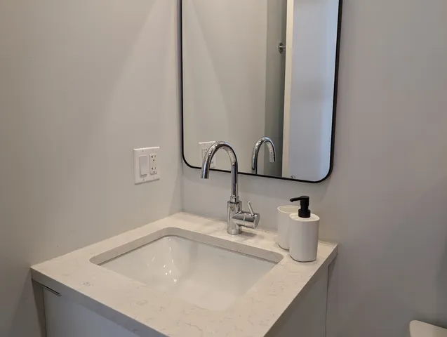 a bathroom with a sink and a mirror