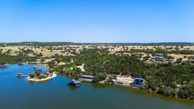 an aerial view of a houses with a lake view