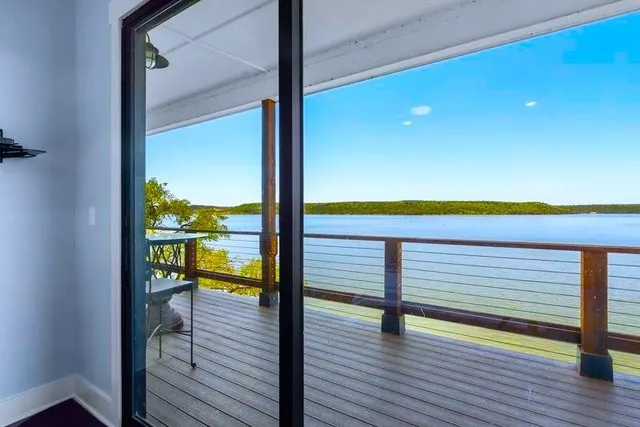 a view of a balcony with floor to ceiling windows with wooden floor