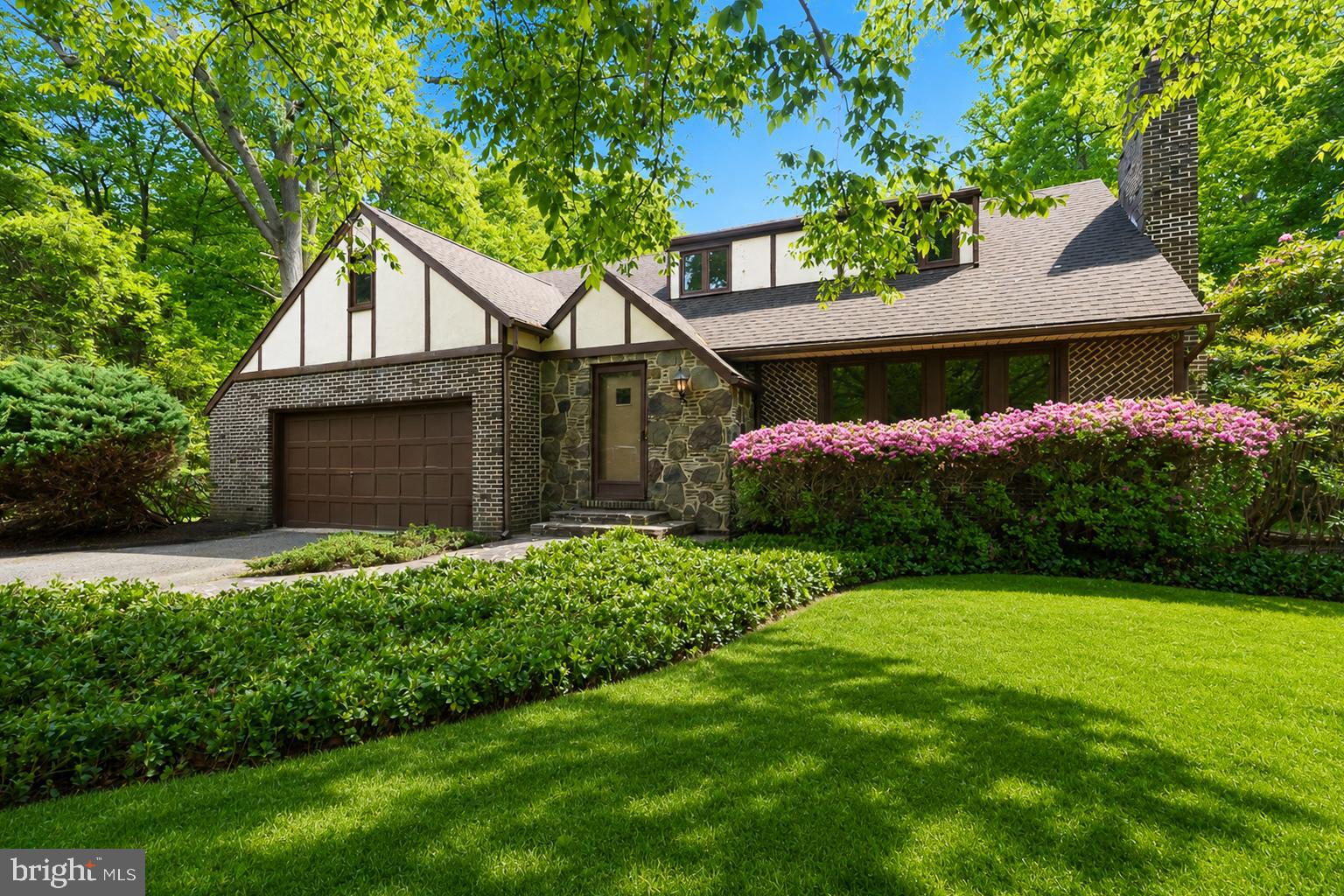 a front view of house with yard and green space
