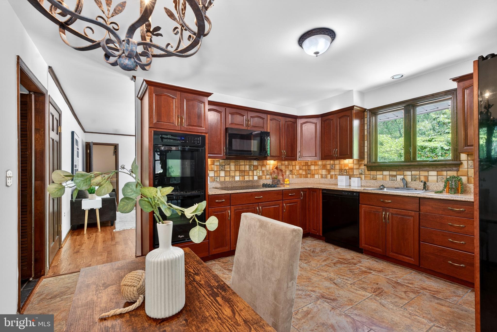 17201 Whiteley Road Monkton, MD 21111 - Photo 15 of 47 a kitchen with stainless steel appliances granite countertop a refrigerator a sink dishwasher a dining table and chairs with wooden floor