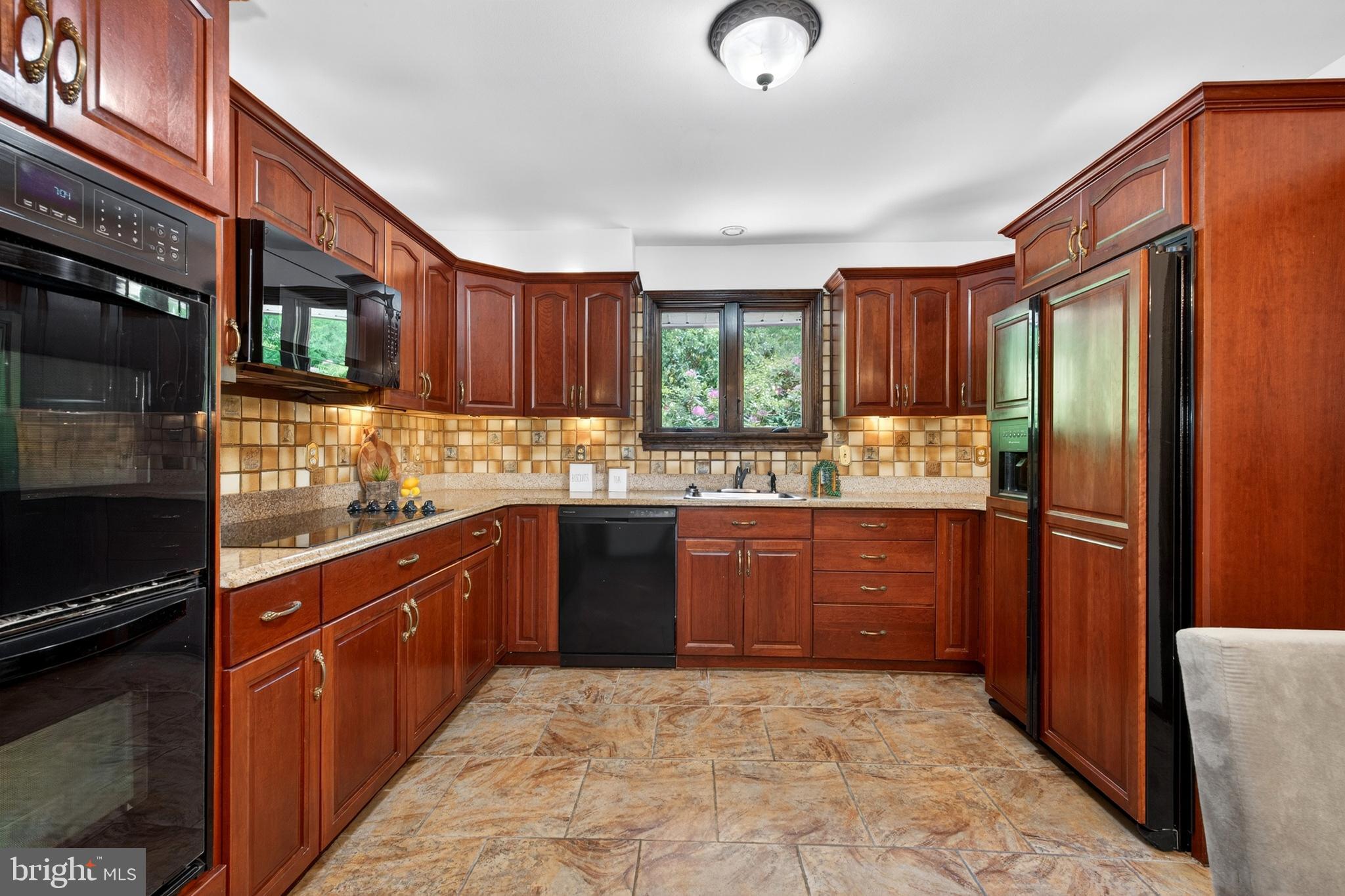 17201 Whiteley Road Monkton, MD 21111 - Photo 16 of 47 a kitchen with stainless steel appliances granite countertop a refrigerator a sink dishwasher a stove with wooden cabinets and floor