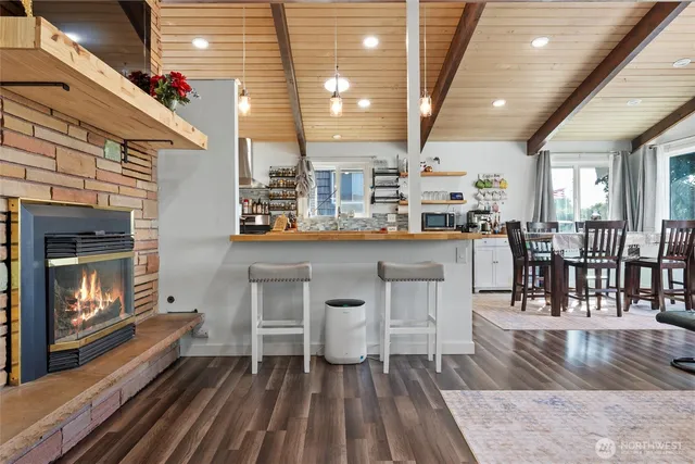 a living room with furniture a flat screen tv and a floor to ceiling window