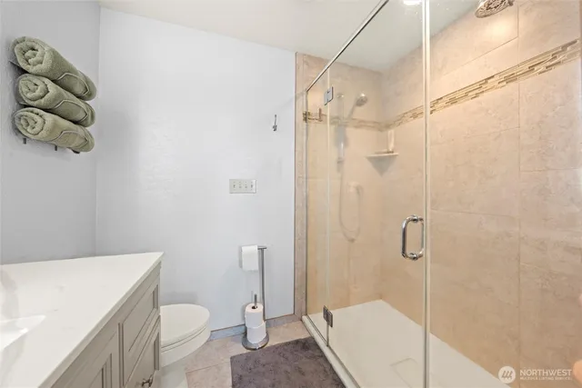 a view of a hallway to a livingroom with wooden floor and stairs