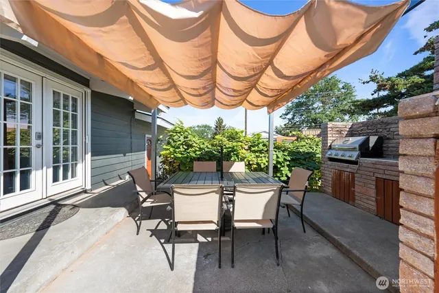 a view of a patio with a table and chairs