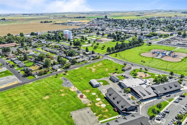 an aerial view of a house with a garden and lake view