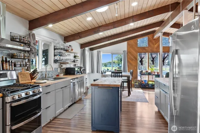 a kitchen with lots of counter top space and stainless steel appliances