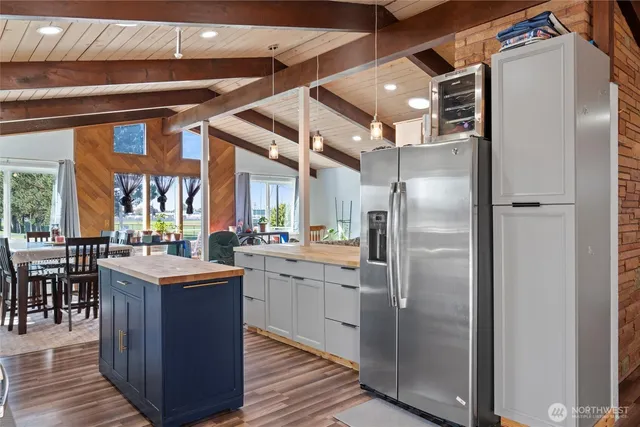 a kitchen with stainless steel appliances granite countertop a refrigerator and a sink