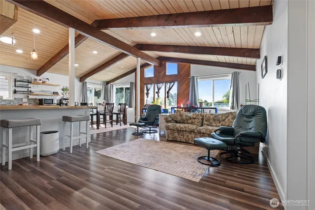 a dining hall with stainless steel appliances granite countertop a stove and cabinets