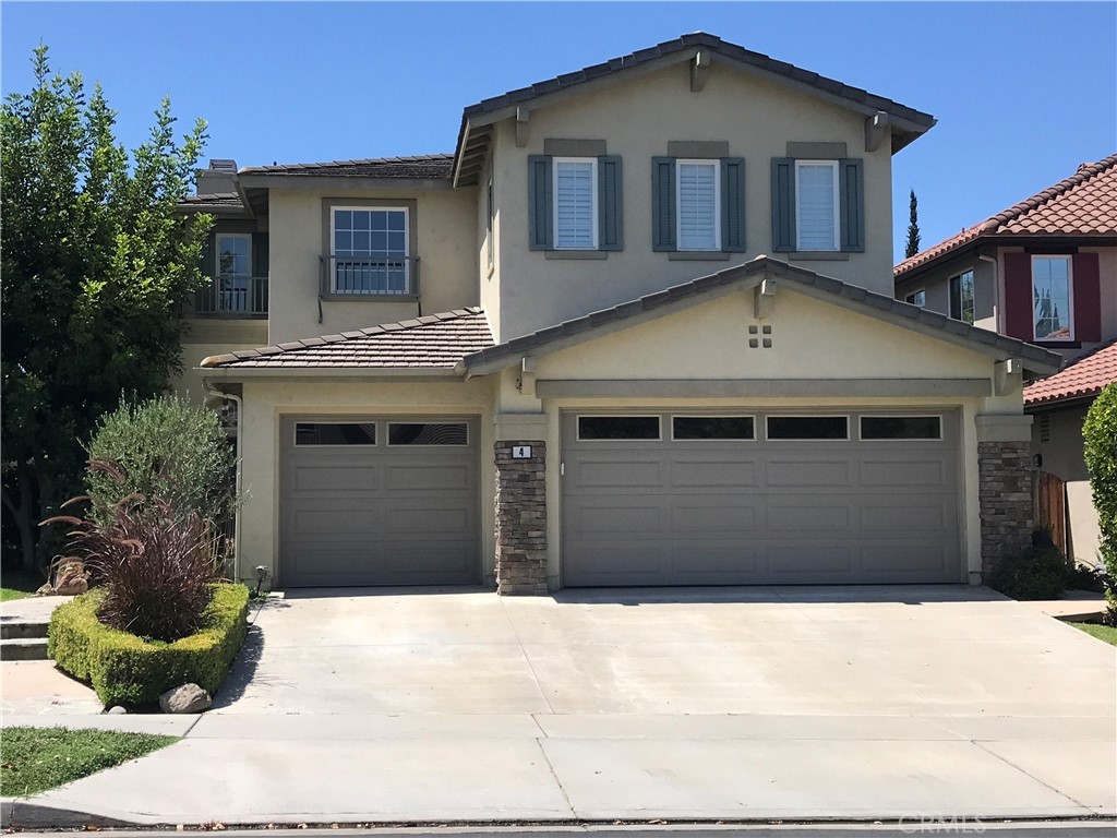 4 Whispering Pine Irvine, CA 92620 - Photo 2 of 3 a front view of a house with a yard
