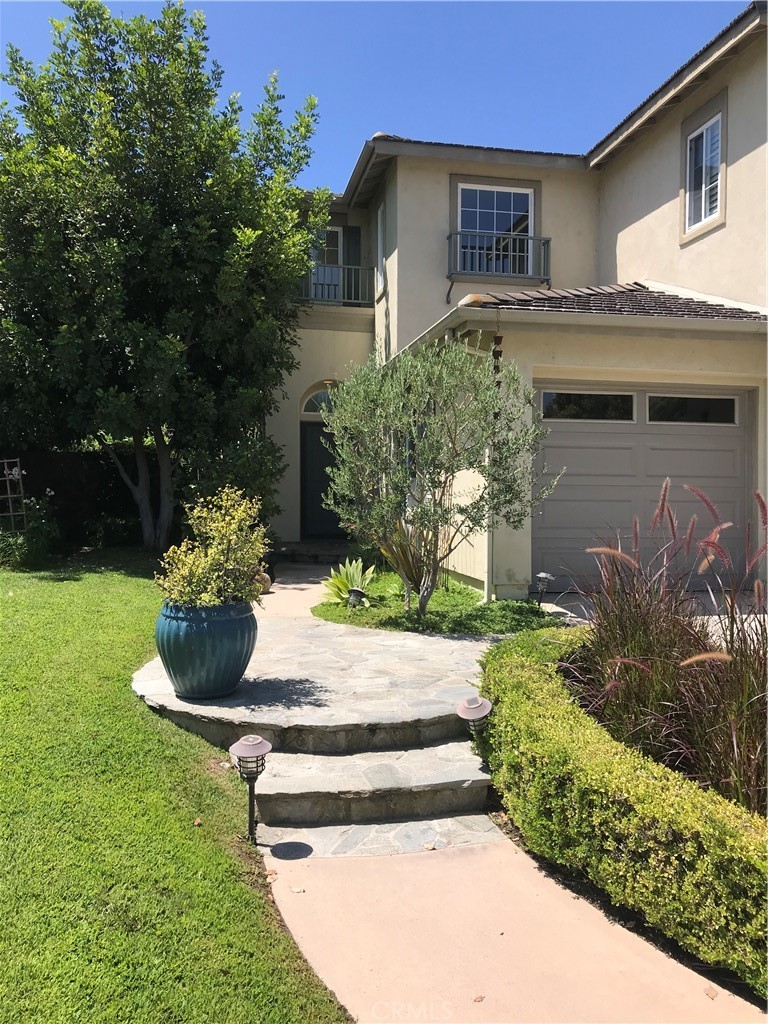 4 Whispering Pine Irvine, CA 92620 - Photo 3 of 3 a front view of a house with a garden