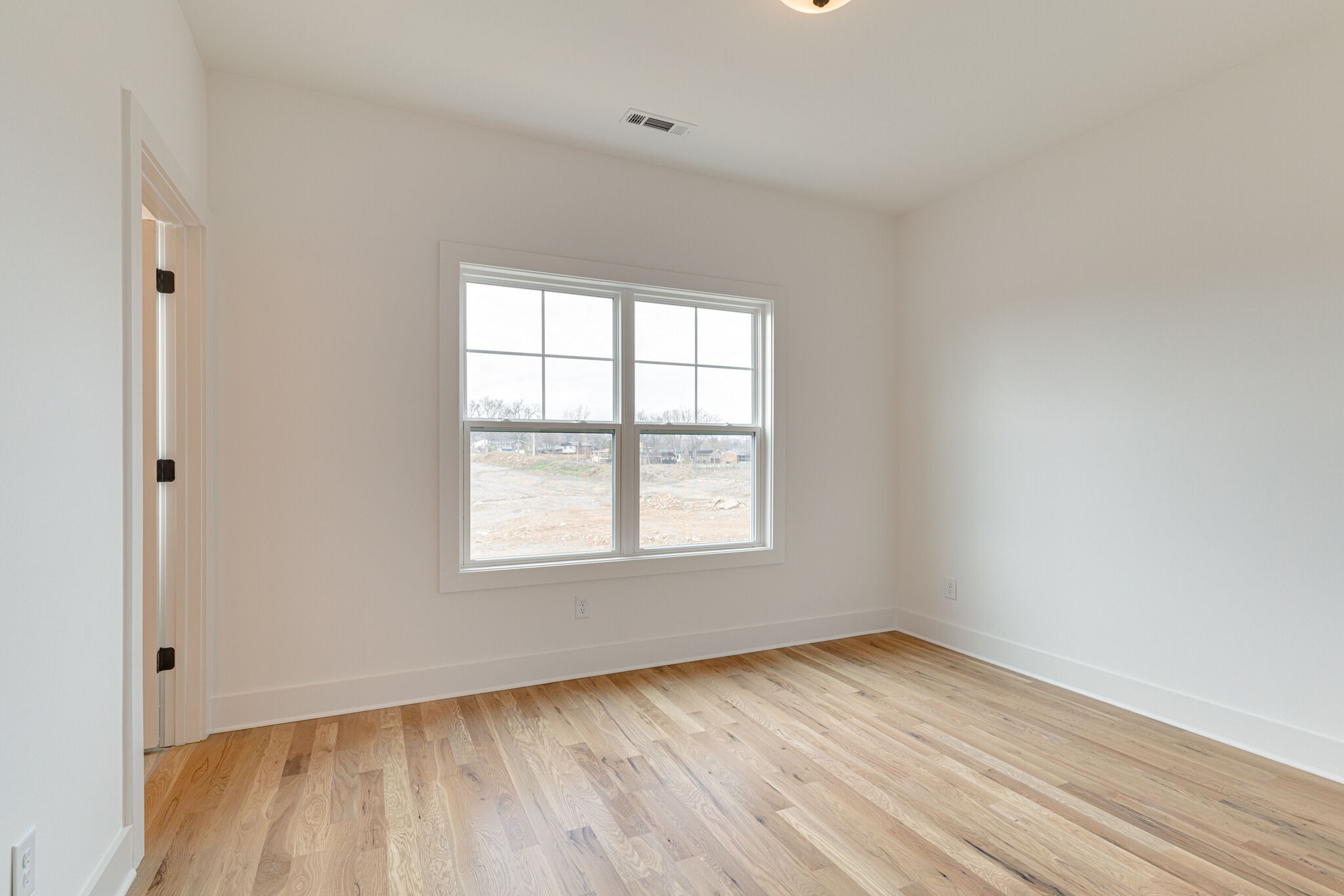 1205 Apache Lane Madison, TN 37115 - Photo 26 of 34 an empty room with wooden floor and windows