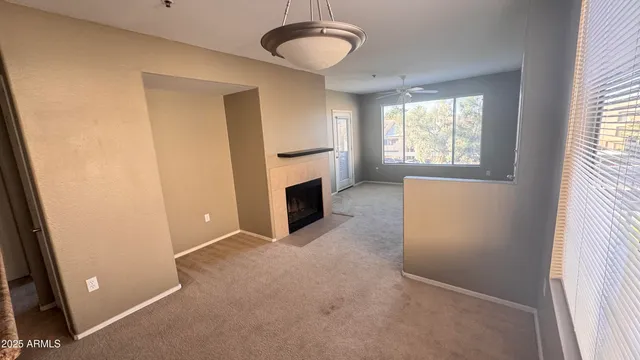 an empty room with windows and cabinet