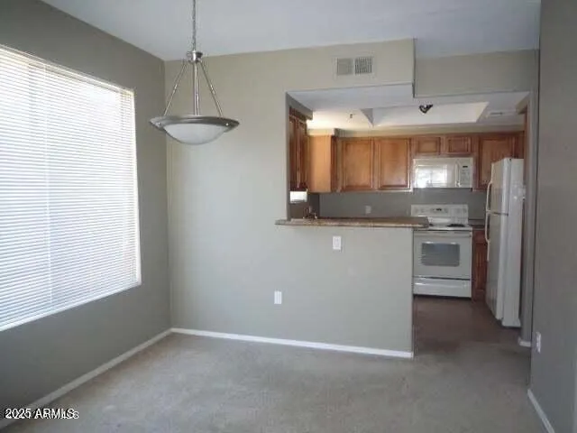 a view of a kitchen with a sink a window and stainless steel appliances