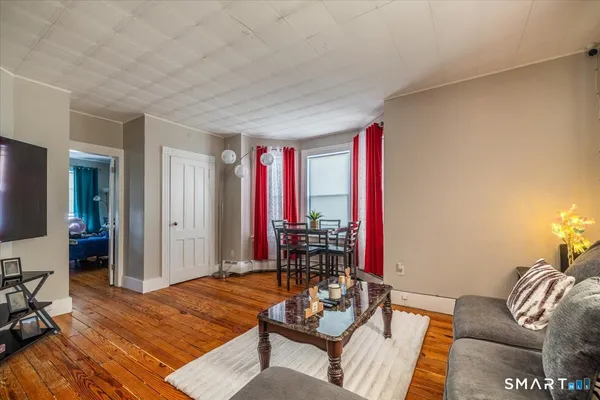 a living room with furniture and a flat screen tv