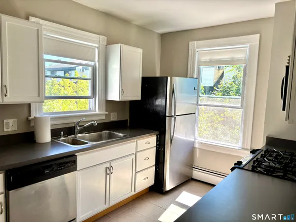 a kitchen with a refrigerator and a sink