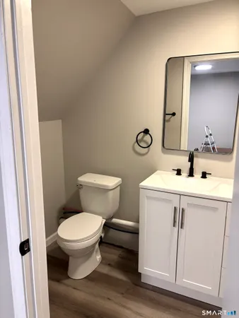 a bathroom with a sink toilet and mirror