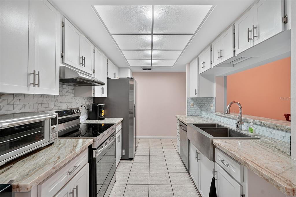 3602 Player Drive New Port Richey, FL 34655 - Photo 11 of 42 a kitchen with stainless steel appliances a sink stove and cabinets
