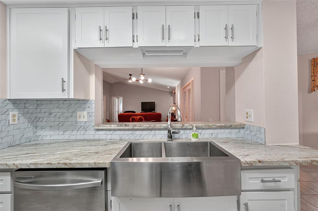 3602 Player Drive New Port Richey, FL 34655 - Photo 12 of 42 a kitchen with granite countertop a sink and cabinets