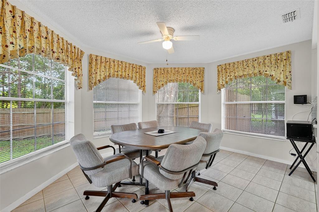3602 Player Drive New Port Richey, FL 34655 - Photo 14 of 42 a dining room with furniture and a floor to ceiling window