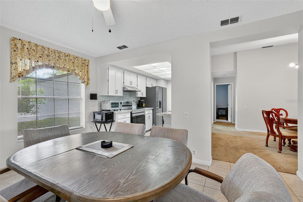 3602 Player Drive New Port Richey, FL 34655 - Photo 15 of 42 a living room with dining table a rug appliances and a large window
