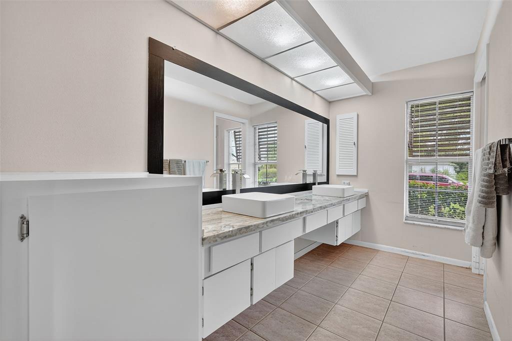 3602 Player Drive New Port Richey, FL 34655 - Photo 25 of 42 a bathroom with a granite countertop sink mirror and a bathtub