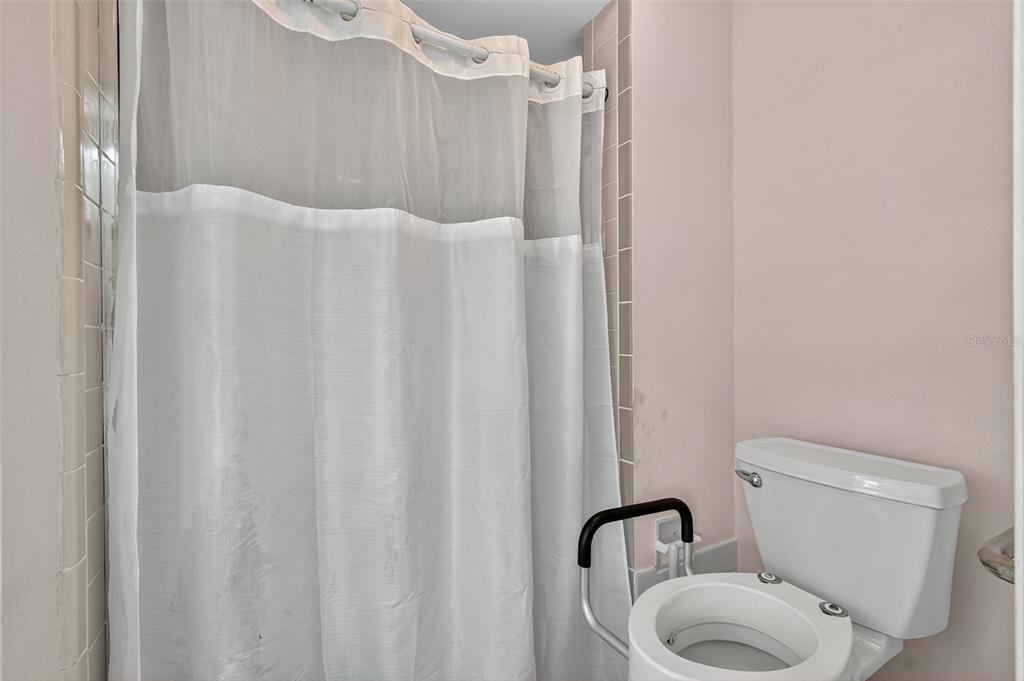 3602 Player Drive New Port Richey, FL 34655 - Photo 27 of 42 a bathroom with a toilet and a shower curtain