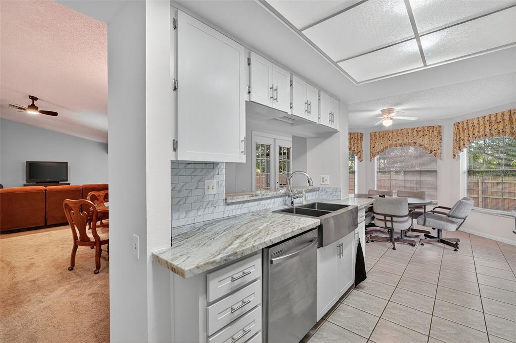 3602 Player Drive New Port Richey, FL 34655 - Photo 9 of 42 a kitchen with granite countertop a sink and a stove