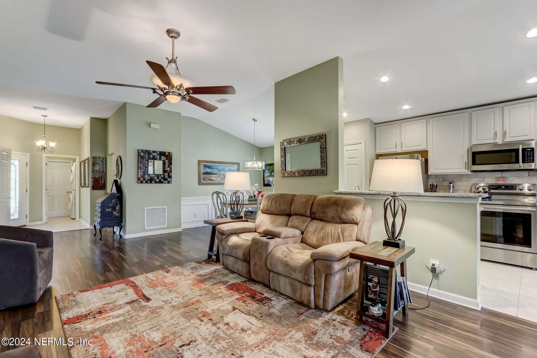11230 Water Spring Circle Jacksonville, FL 32256 - Photo 12 of 91 a living room with furniture a flat screen tv and kitchen view