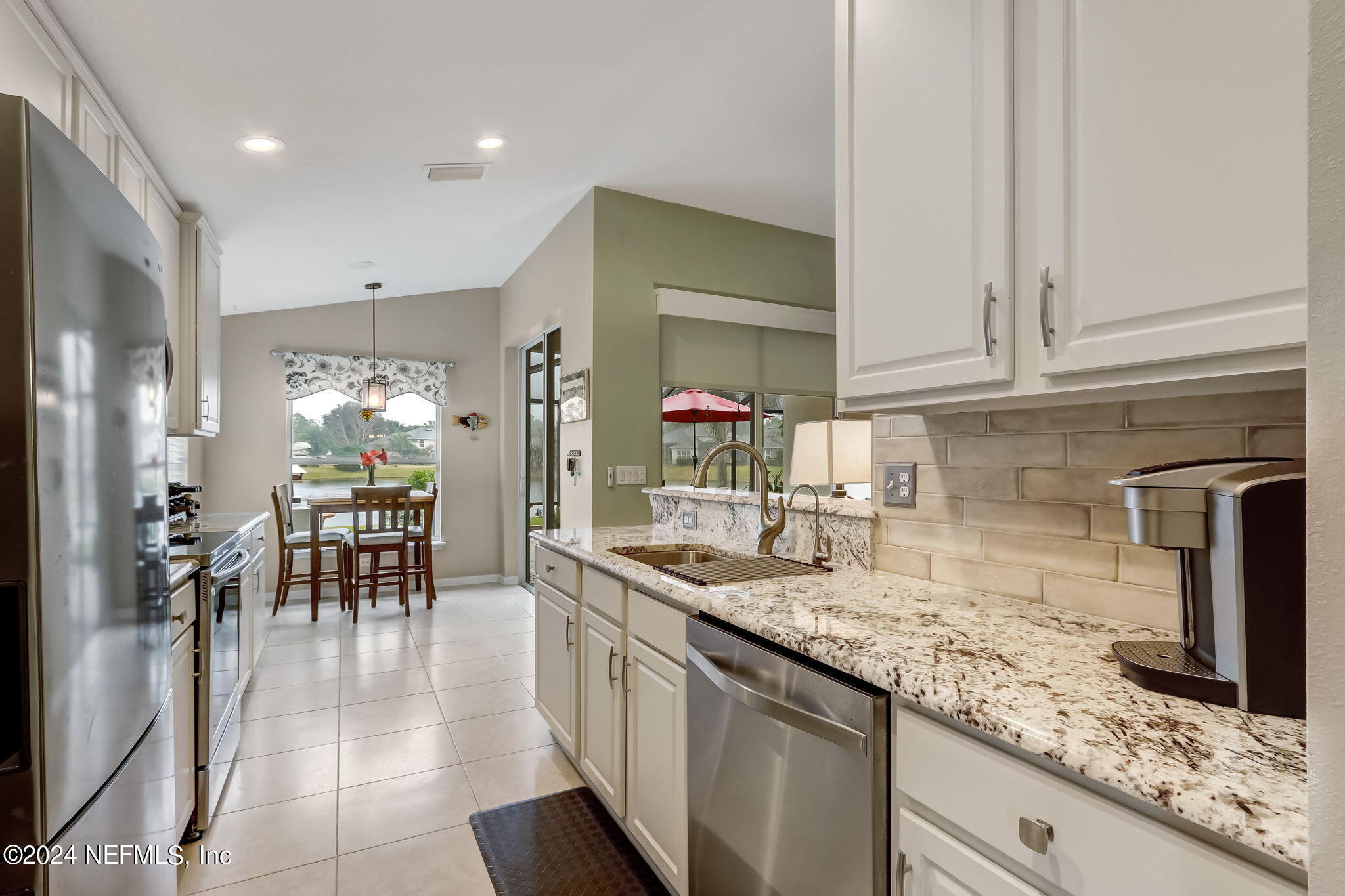 11230 Water Spring Circle Jacksonville, FL 32256 - Photo 17 of 91 a kitchen with lots of counter top space and dining table
