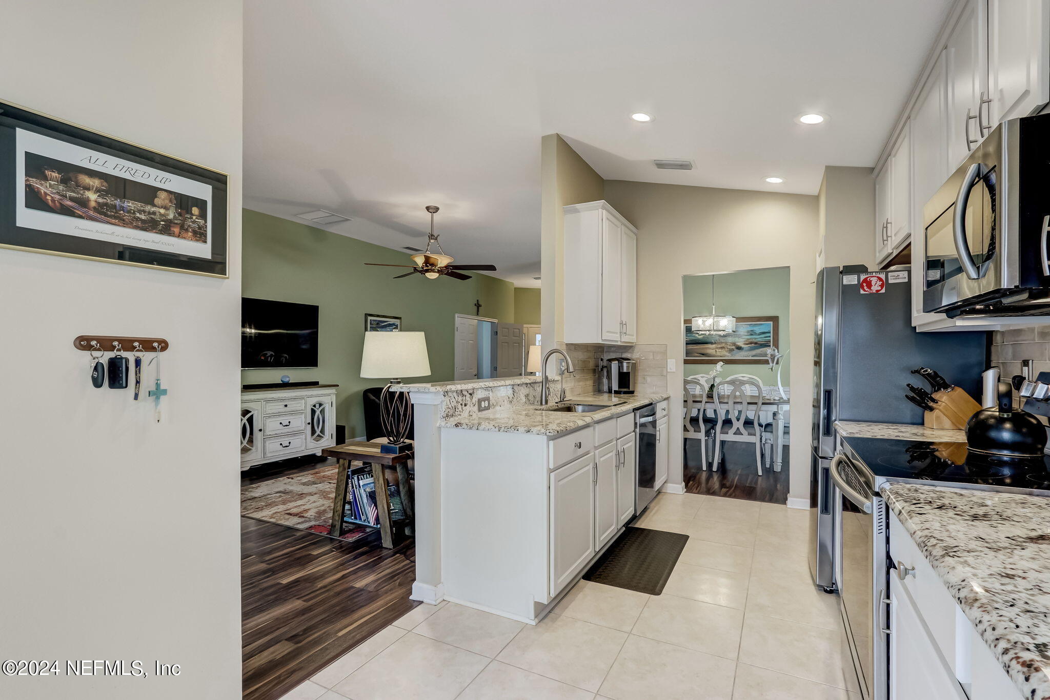 11230 Water Spring Circle Jacksonville, FL 32256 - Photo 20 of 91 a kitchen with stainless steel appliances kitchen island granite countertop a stove top oven a sink a counter top space and cabinets