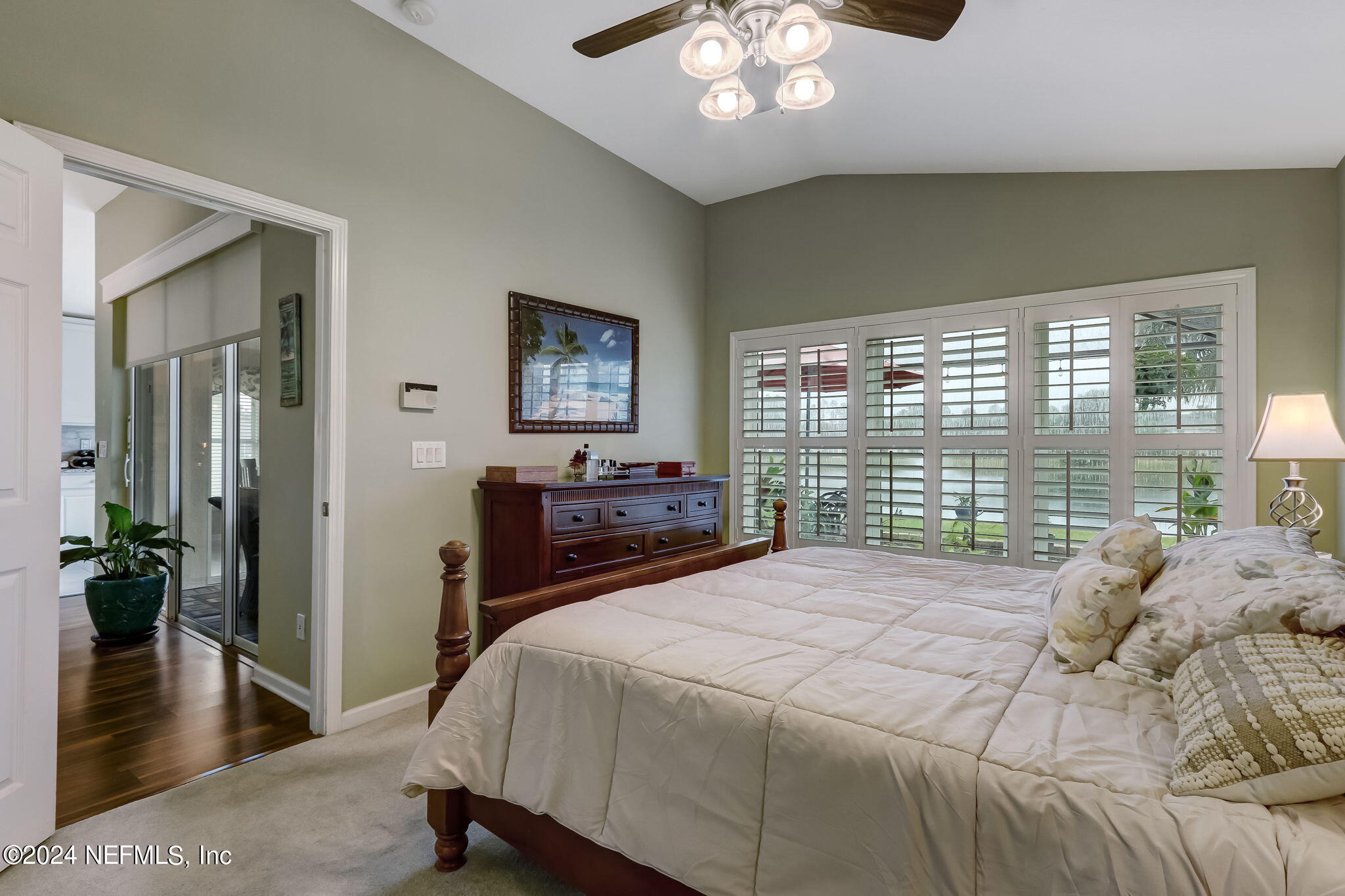 11230 Water Spring Circle Jacksonville, FL 32256 - Photo 25 of 91 a bedroom with a large bed and a chandelier