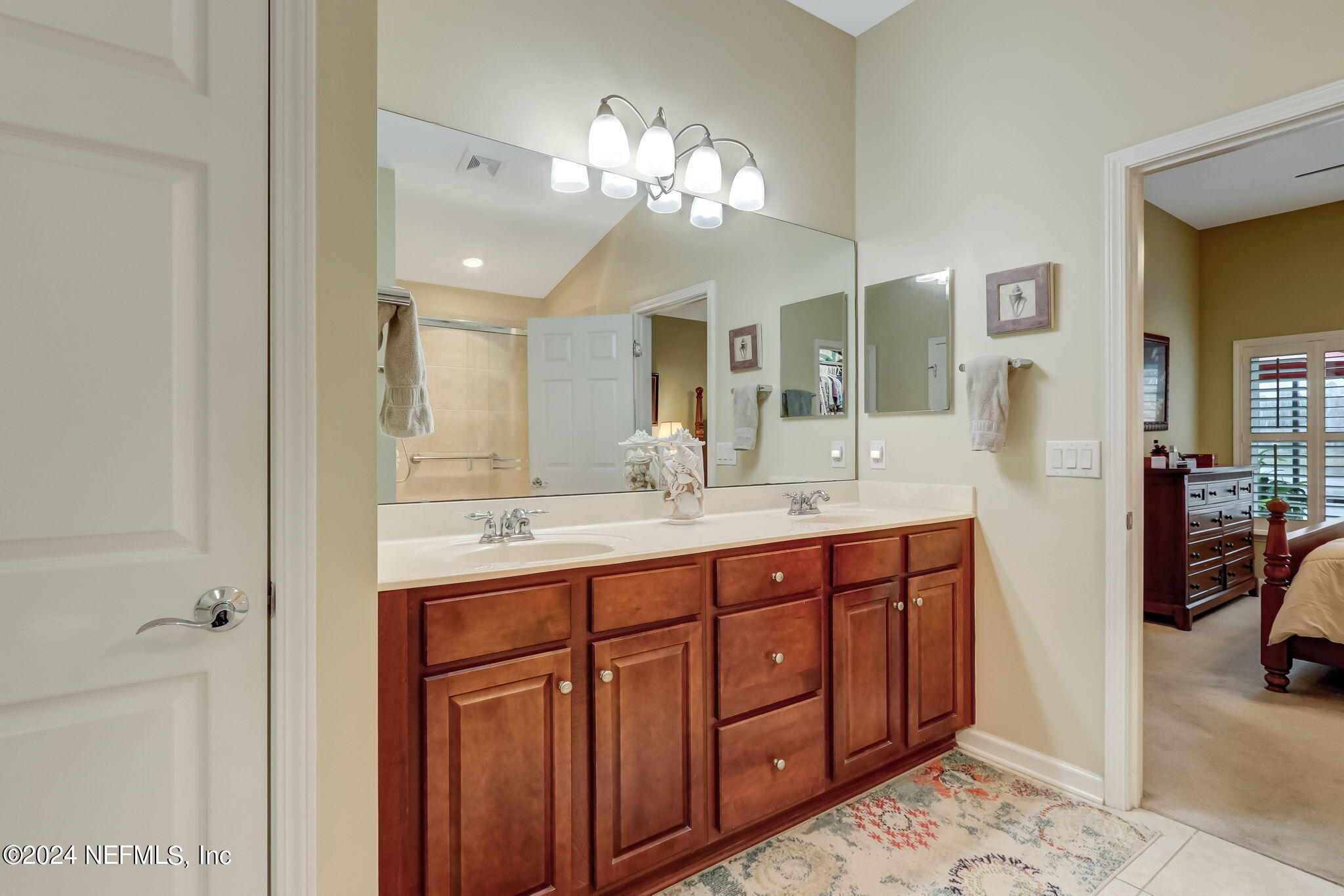 11230 Water Spring Circle Jacksonville, FL 32256 - Photo 28 of 91 a bathroom with a double vanity sink and a mirror