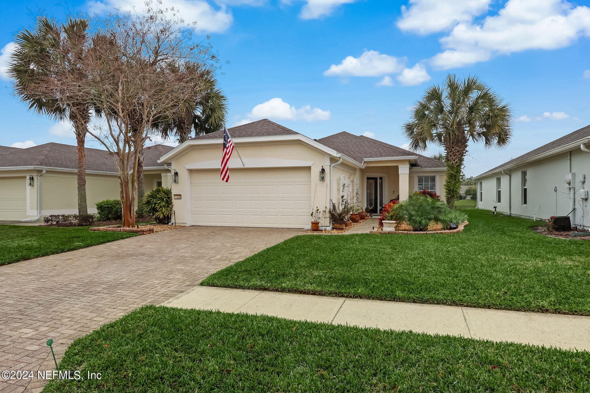 11230 Water Spring Circle Jacksonville, FL 32256 - Photo 3 of 91 a front view of a house with a garden and yard