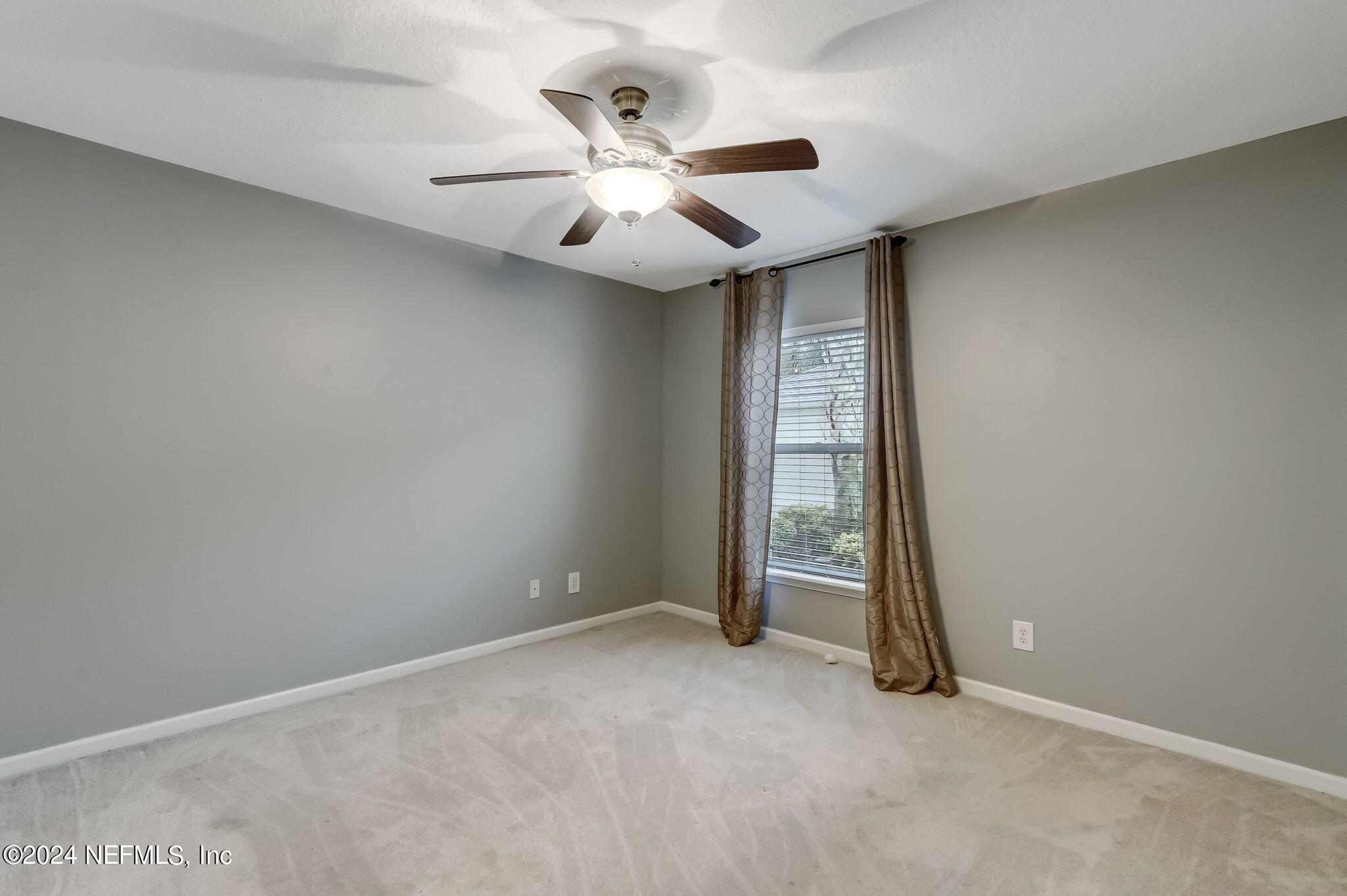11230 Water Spring Circle Jacksonville, FL 32256 - Photo 33 of 91 an empty room with closet and a chandelier fan