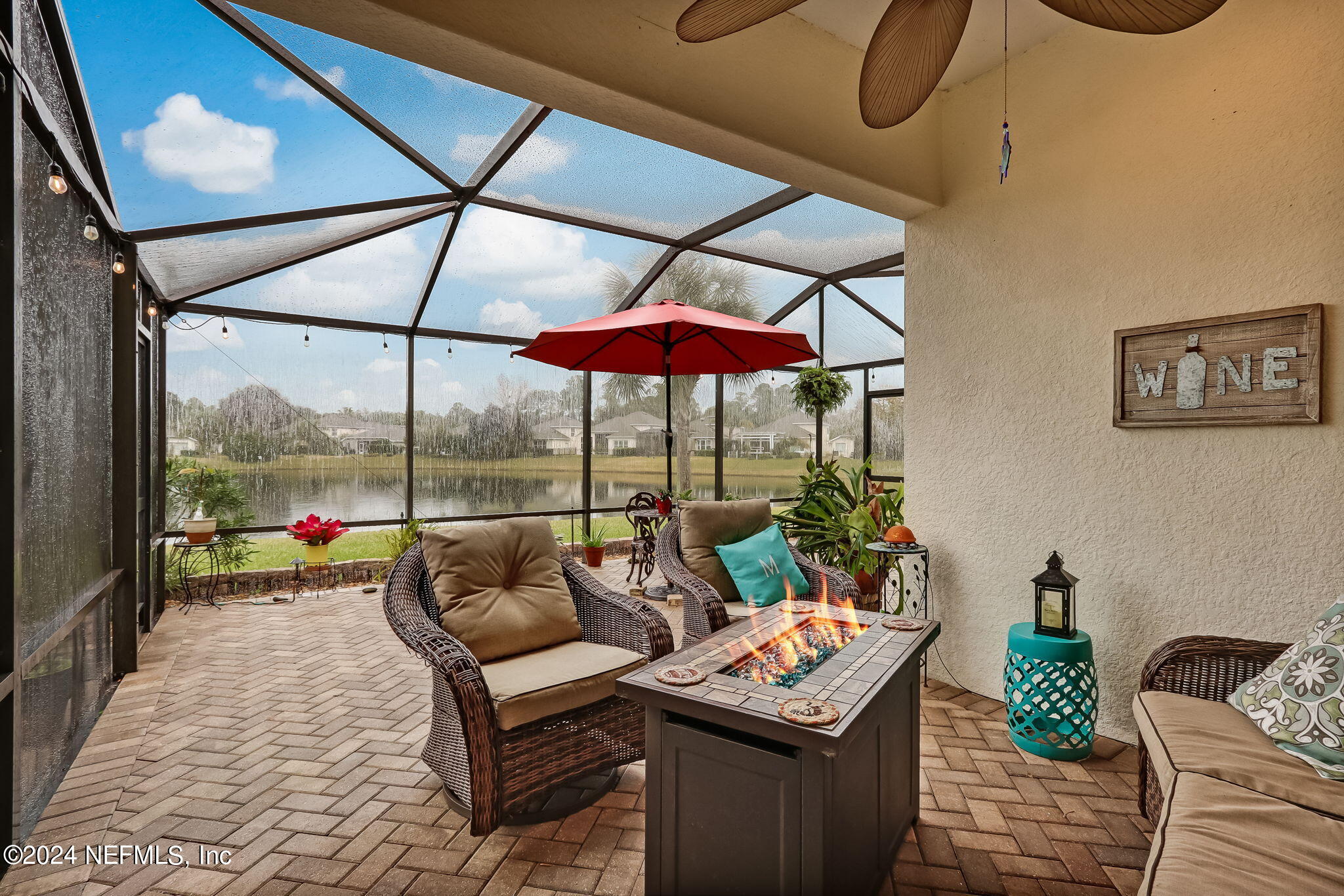11230 Water Spring Circle Jacksonville, FL 32256 - Photo 35 of 91 a living room with furniture and a floor to ceiling window