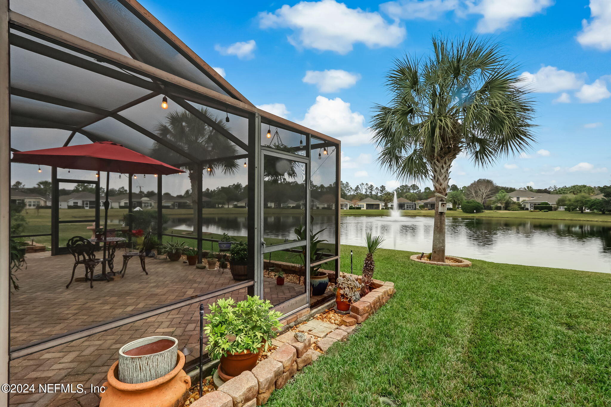 11230 Water Spring Circle Jacksonville, FL 32256 - Photo 41 of 91 a view of a patio with a table chairs and a swimming pool