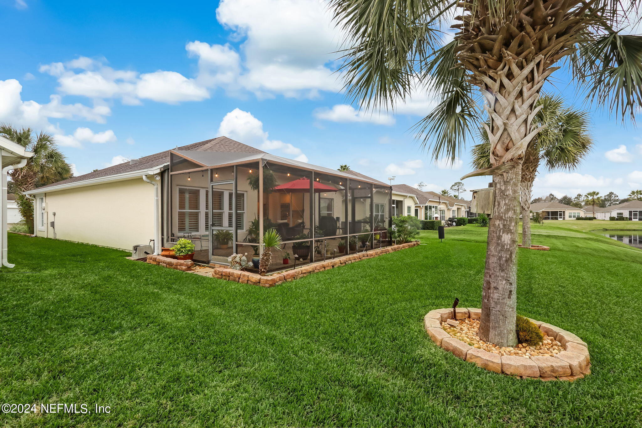 11230 Water Spring Circle Jacksonville, FL 32256 - Photo 43 of 91 a view of a house with a yard and palm trees