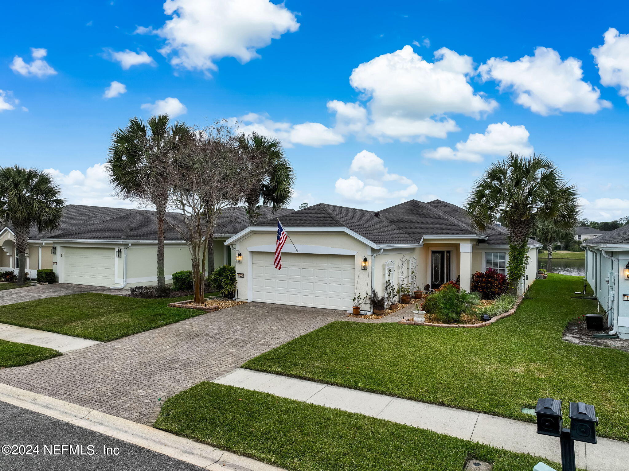 11230 Water Spring Circle Jacksonville, FL 32256 - Photo 47 of 91 a front view of a house with a garden and yard