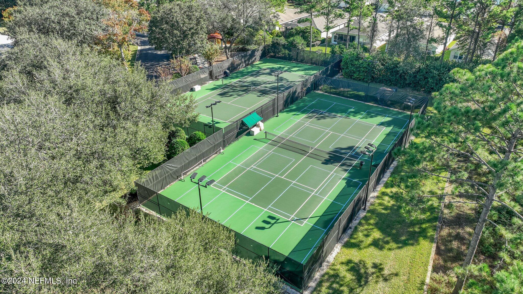 11230 Water Spring Circle Jacksonville, FL 32256 - Photo 60 of 91 an aerial view of a tennis ground and large trees