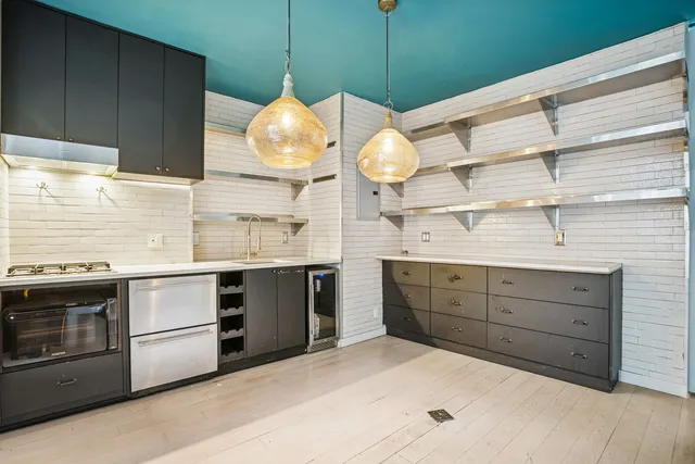 a kitchen with a cabinets and wooden floor