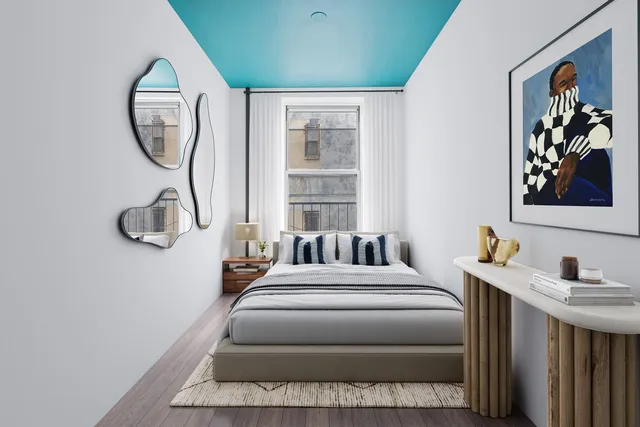 a bedroom with a large bed and a window