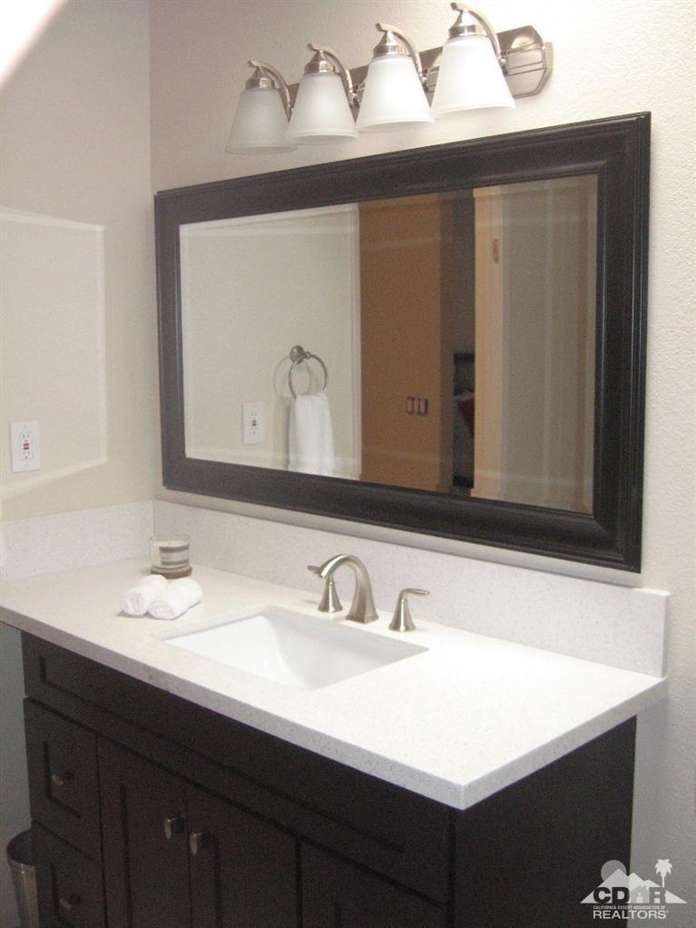 200 East Racquet Club Road, Unit 52 Palm Springs, CA 92262 - Photo 11 of 28 a bathroom with a sink and a mirror