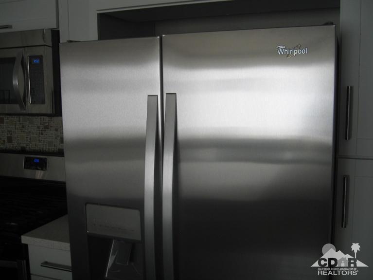 200 East Racquet Club Road, Unit 52 Palm Springs, CA 92262 - Photo 16 of 28 a bathroom with a glass shower door