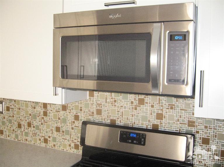 200 East Racquet Club Road, Unit 52 Palm Springs, CA 92262 - Photo 17 of 28 a bathroom with a sink and a mirror