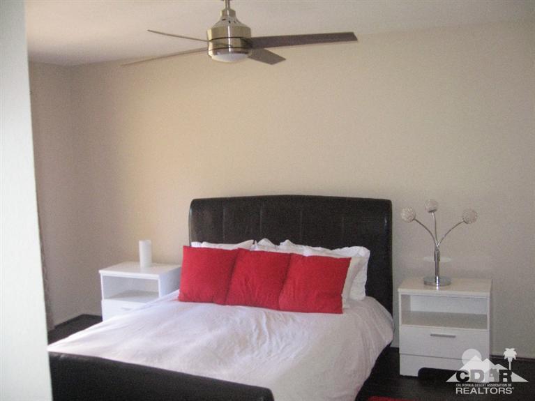 200 East Racquet Club Road, Unit 52 Palm Springs, CA 92262 - Photo 6 of 28 a bedroom with a bed and a night stand