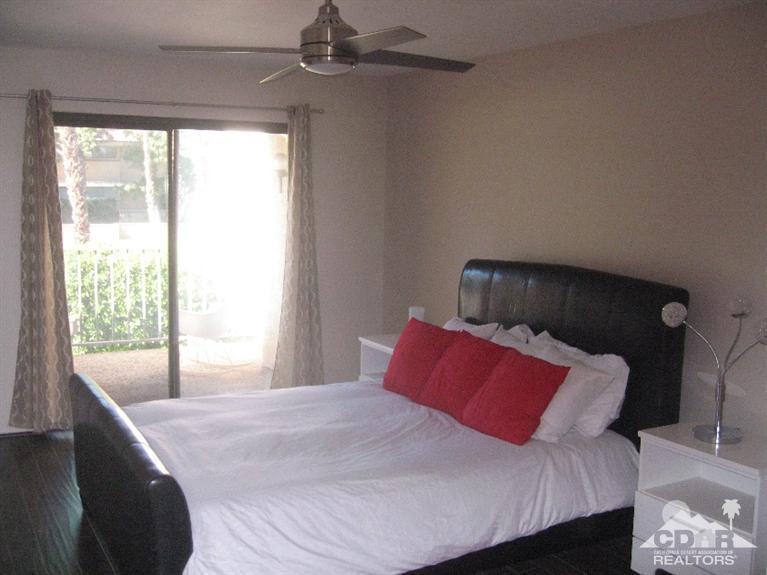 200 East Racquet Club Road, Unit 52 Palm Springs, CA 92262 - Photo 7 of 28 a bedroom with a bed and window