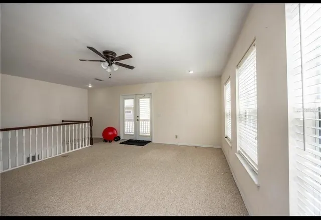 a view of a livingroom with a ceiling fan and window